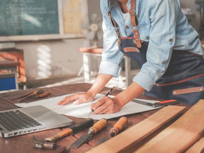 carpenter-working-with-equipment-wooden-table-carpentry-shop_1418-2331